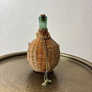 Vintage wicker wrapped green glass jar with cork